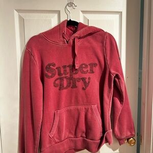 This product is a Rusty Pink SuperDry hoodie in a size 8 in women's.